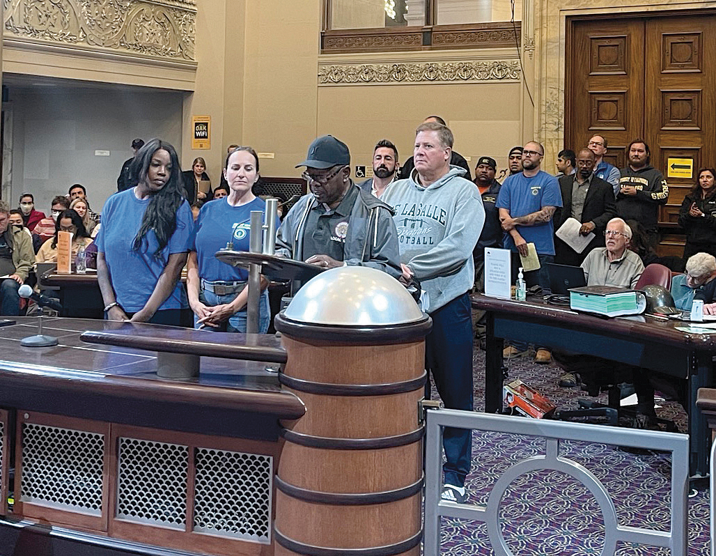 Local 1245 advisory council member Michael Patterson testifies before the Oakland City Council in support of the safe-work-zone ordinance, flanked by fellow 1245 organizing stewards who stood with him to show support.