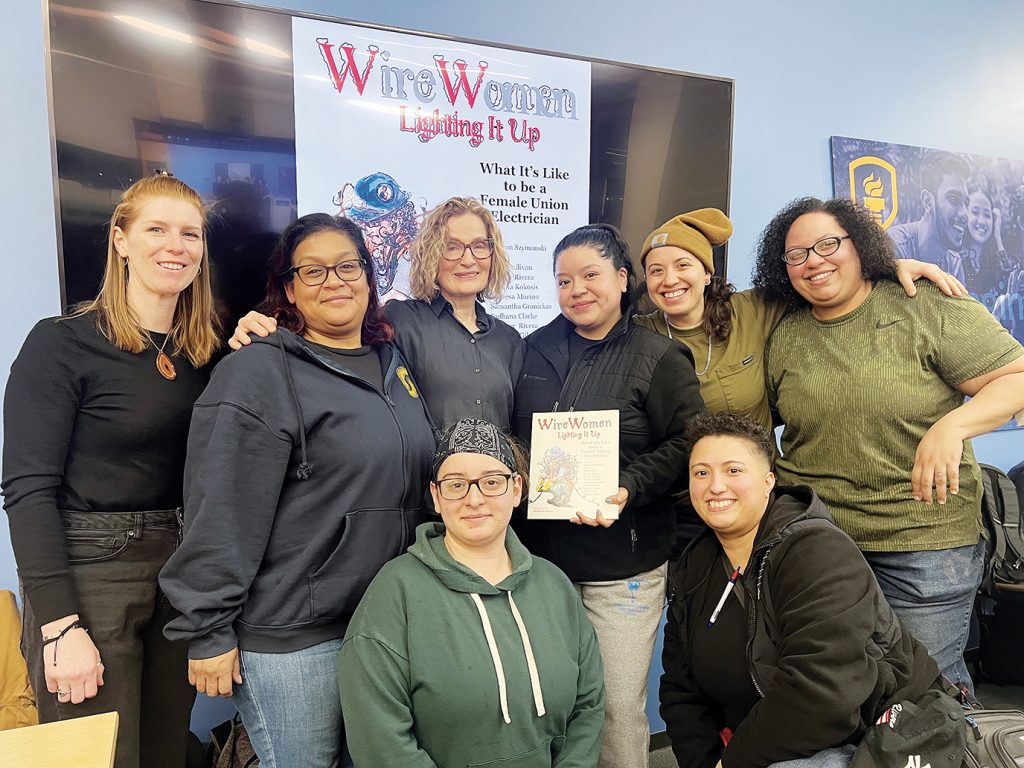 Motivated by a question posed in class at Empire State College, New York Local 3 apprentices collaborated with professor Sharon Szymansk (back row, third from left) on a children’s book to show young girls what it’s like to be a union electrician.