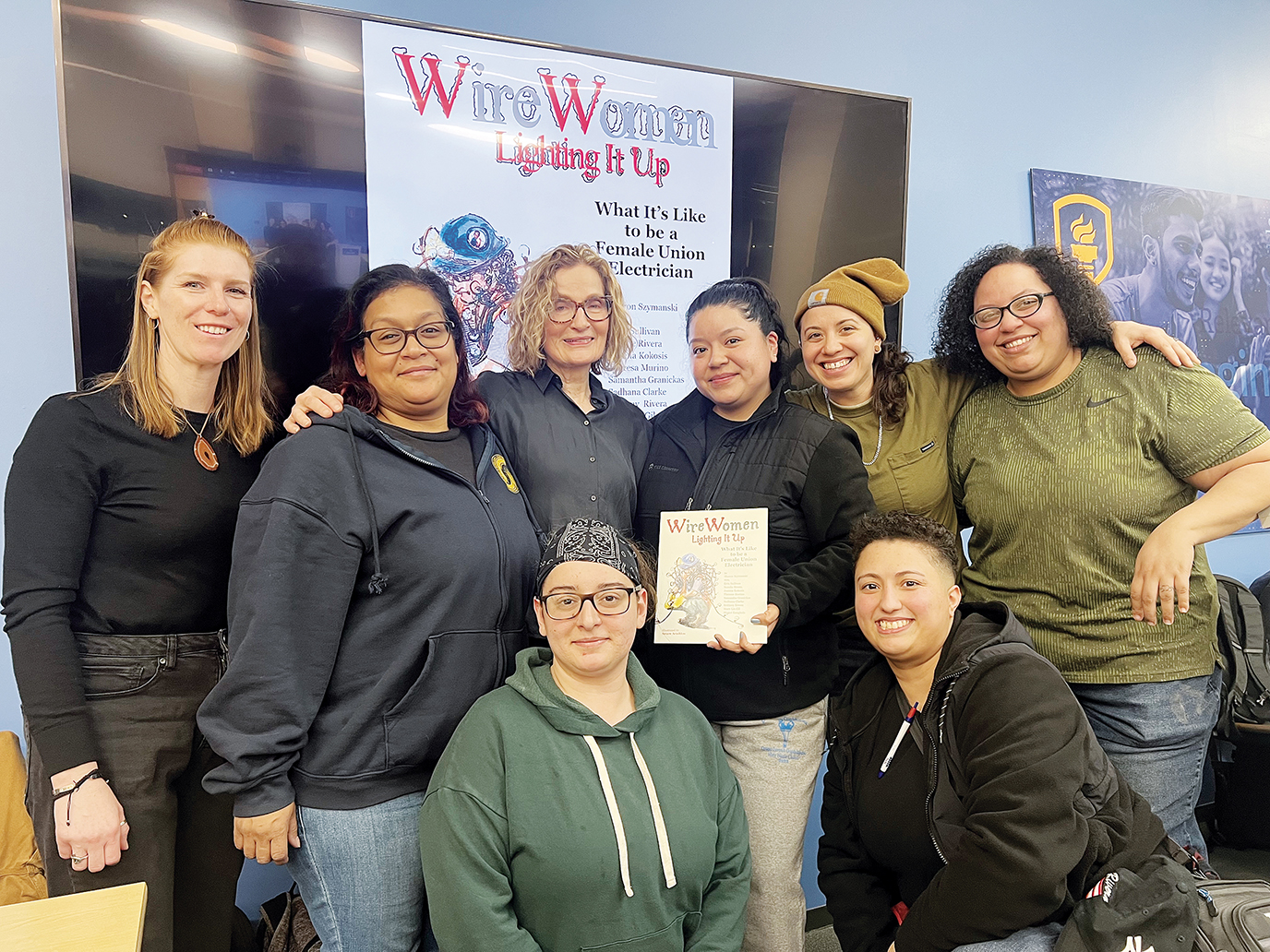 Motivated by a question posed in class at Empire State College, New York Local 3 apprentices collaborated with professor Sharon Szymansk (back row, third from left) on a children’s book to show young girls what it’s like to be a union electrician.