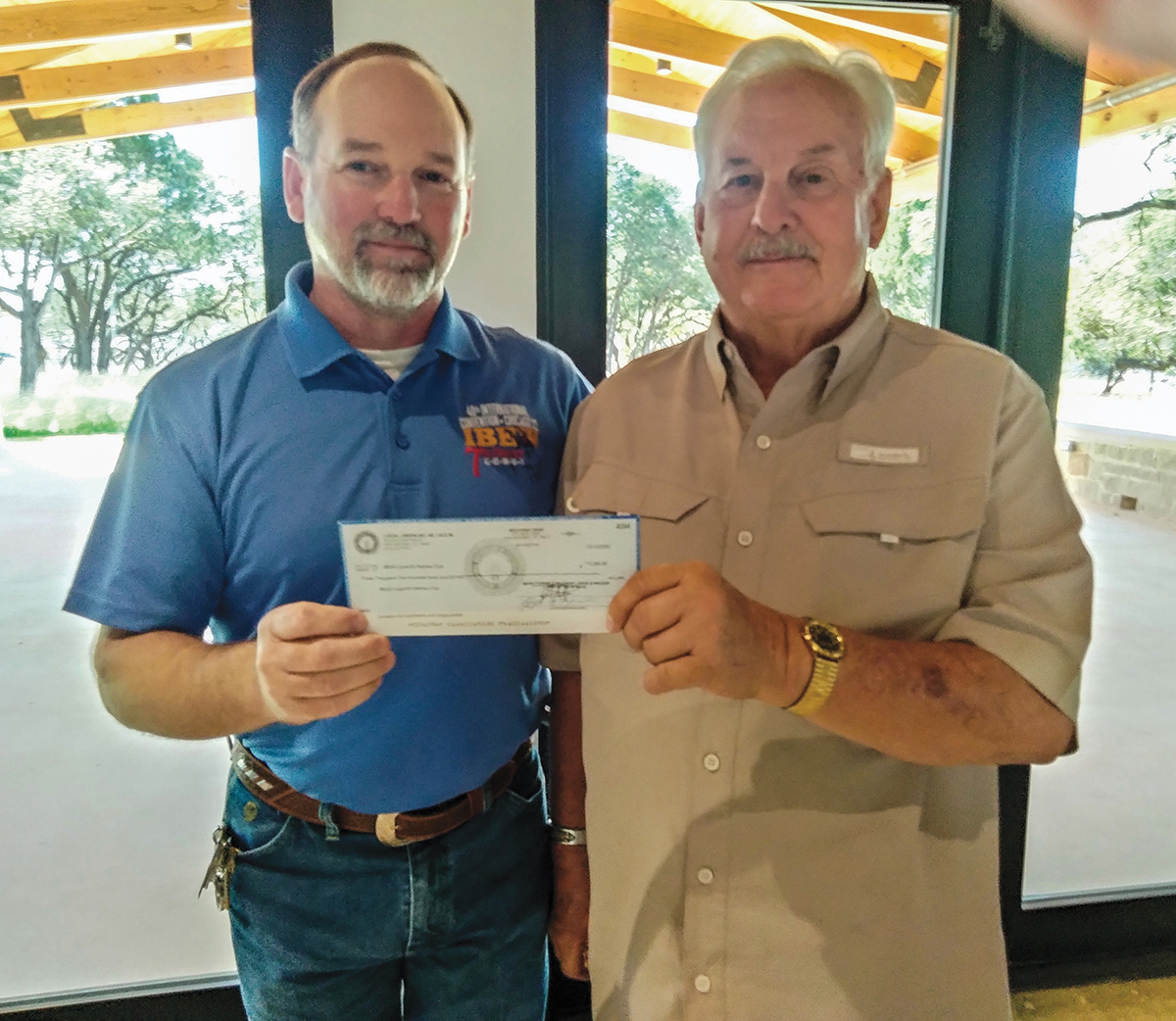 Local 60 Retirees’ Club President Coy Rogers receiving a donation from Business Manager Gary Aiken.