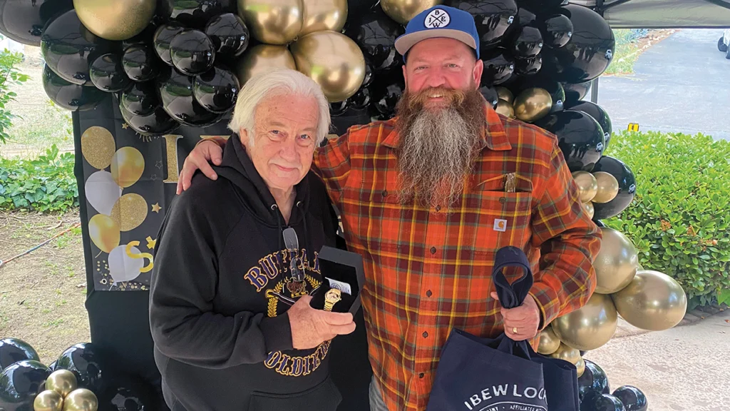 Local 47 Business Manager Colin Lavin presents Senior Assistant Business Manager Stan Stosel with his retirement watch after 37 years of supporting labor.