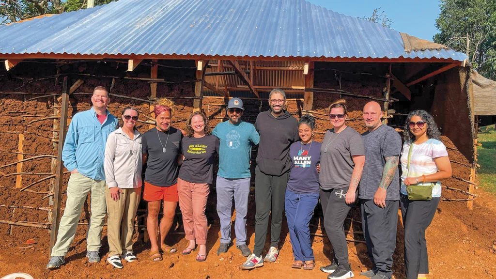 Local 16 member Sara Schapker with her team in Kenya, who worked with the JD Sheth Foundation on a wattle-and-daub home for a widow with 10 children.