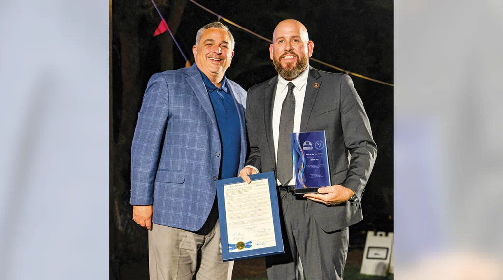 Local 302 Business Manager Julian Vinatieri accepts the Union of the Year Award from Contra Costa Building and Construction Trades Council Executive Director Tim Sbranti.
