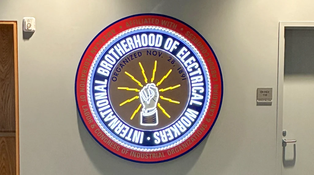 An illuminated IBEW logo graces Local 68’s new hall’s lobby.