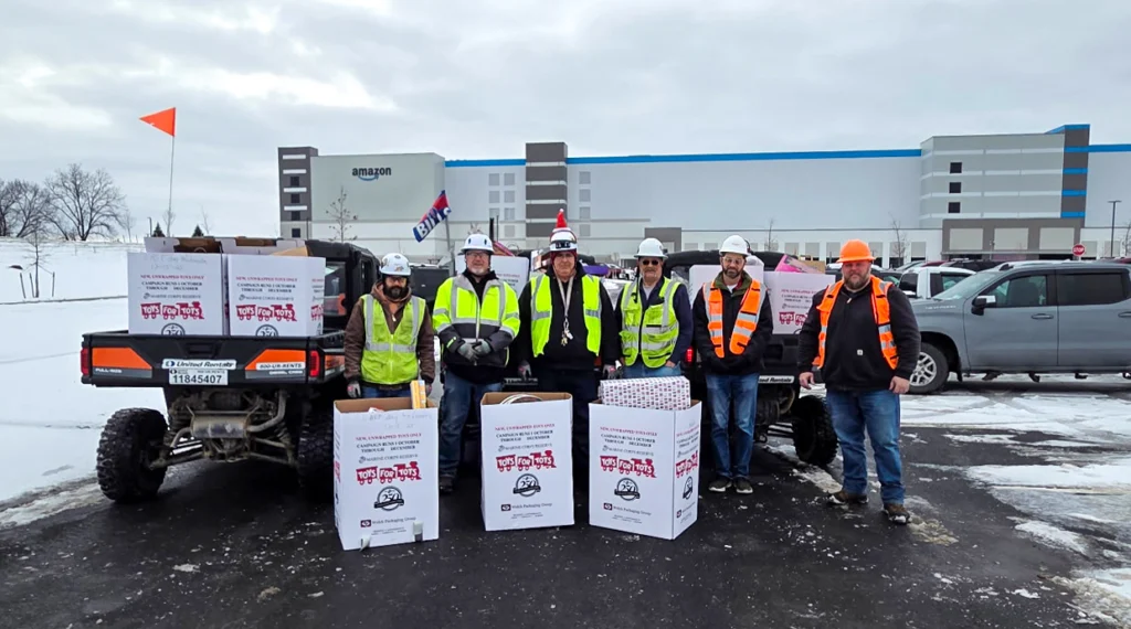 From left, Local 237 members Andrew Reed, Rod McGill, Mike Baker, Jim Lines, John Scherrer and Nick Coyle volunteer at the Marine Toys for Tots Christmas toy drive at Amazon’s Project Fifi jobsite in Niagara, N.Y.