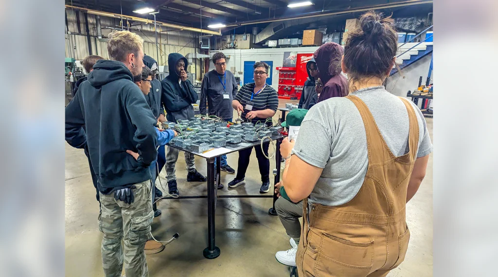 Local 601’s Sister Cara Siegel helps prospective students understand the workings of a circuit.